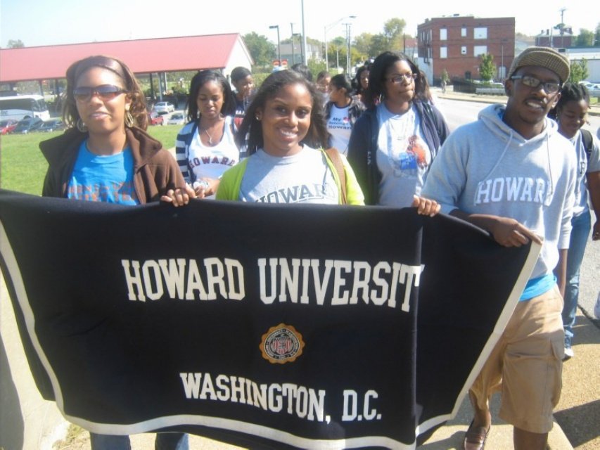 Sajdah marching with classmates holding a Howard University, Washington D.C. banner