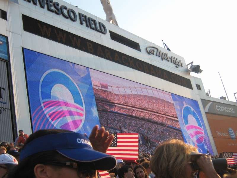 Exterior of Invesco Field with a large screen showing the packed stadium crowd